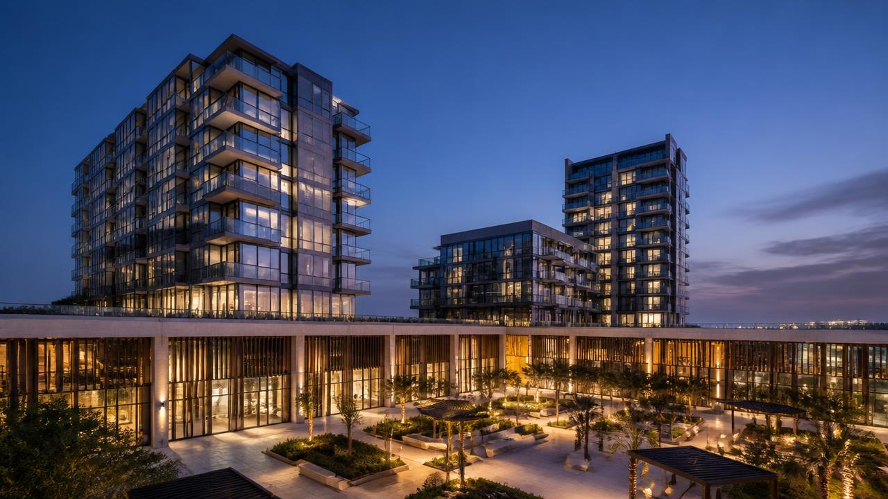 Residential towers above a retail podium at dusk, representing the mixed-use development sector